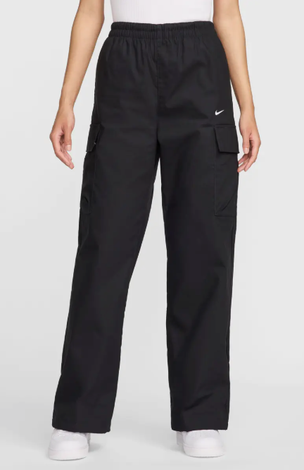 Person wearing black cargo pants with a Nike logo on a white background