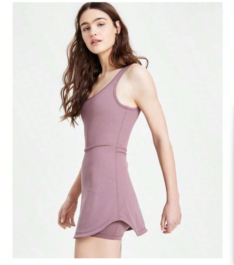 Woman wearing a mauve dress on a white background