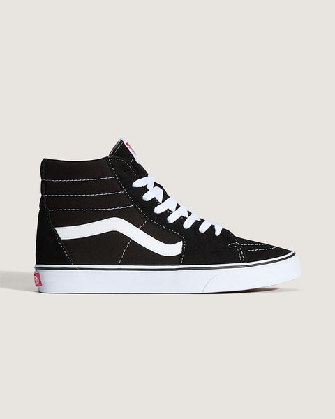 Black high-top sneaker with white laces on a light beige background