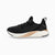 A Puma sneaker in black with a white midsole and a metallic bronze accent, shown from the side on a light gray background.