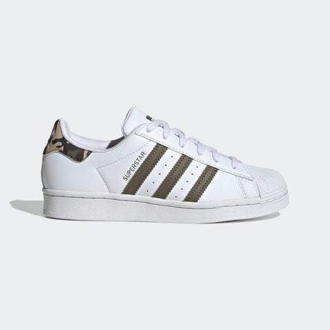 White Adidas Superstar sneakers with three green stripes on a light gray background