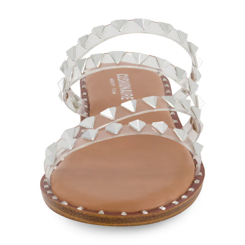 White sandal with studded details on a white background