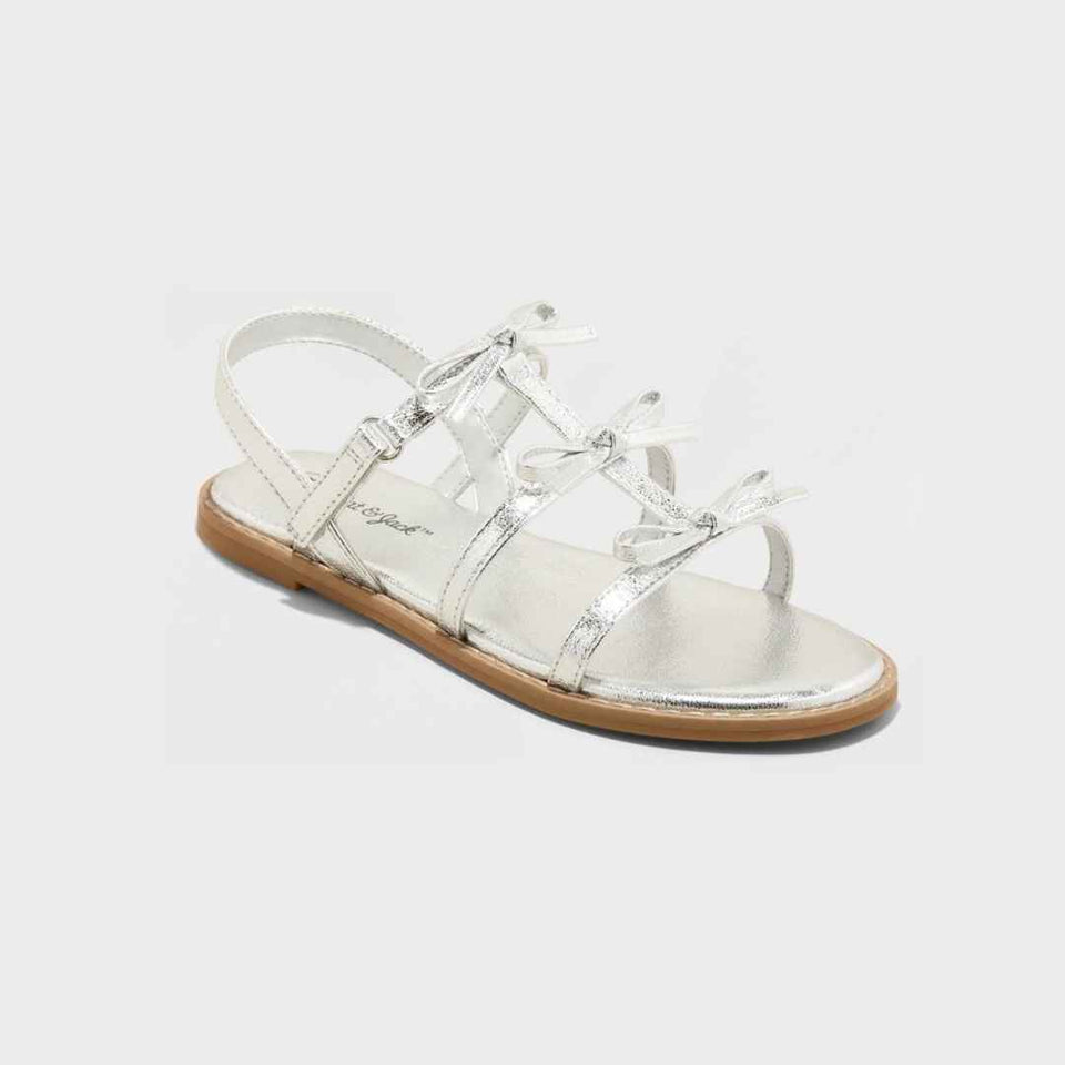Silver sandal with a brown sole on a white background