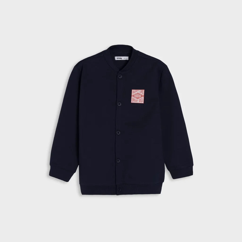 A dark navy blue button-up cardigan jacket with a small red and white graphic patch on the left chest, displayed on a light gray background.
