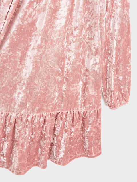 Pink textured dress with long sleeves on a light gray background