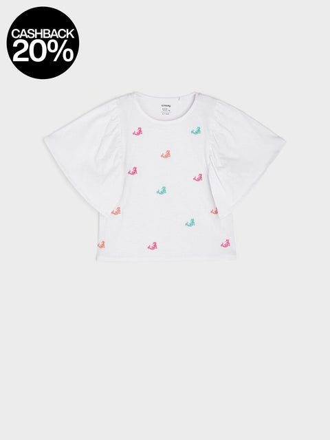 White t-shirt with colorful flamingo patterns on a white background