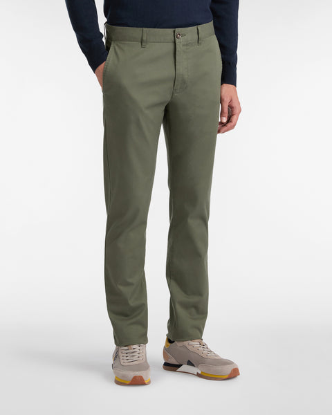Person wearing green pants on a white background
