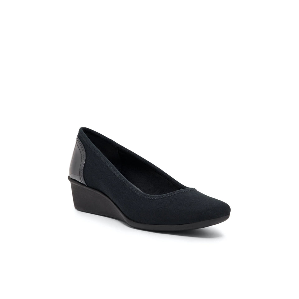 A single black wedge pump shoe with a smooth fabric upper and a contrasting black patent leather heel counter, shown from a three-quarters angle on a white background.