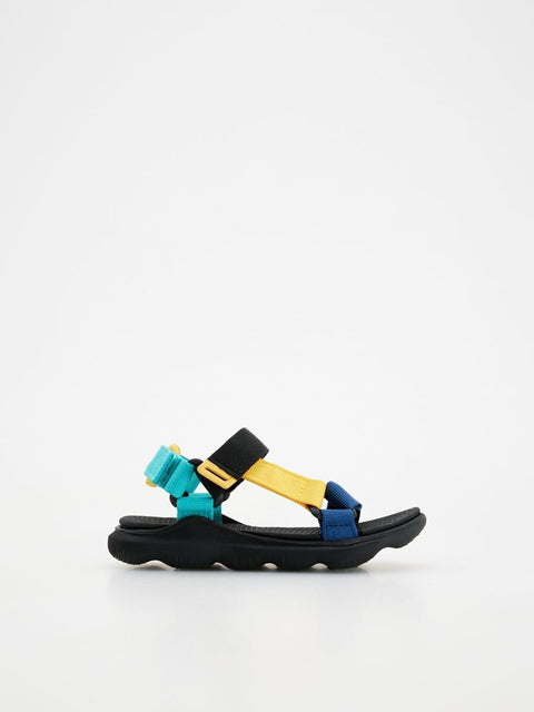 Black sandal with colorful straps on a white background