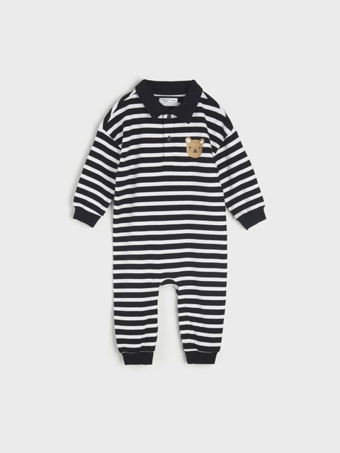 Black and white striped baby romper with a small logo on a light gray background