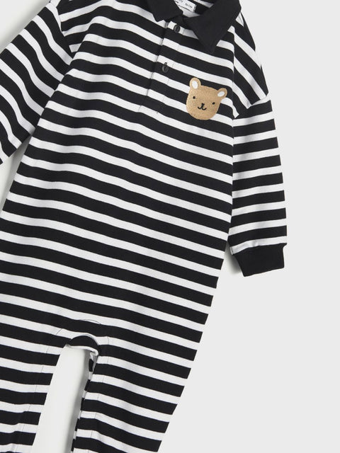 Black and white striped onesie with a bear face patch on a white background