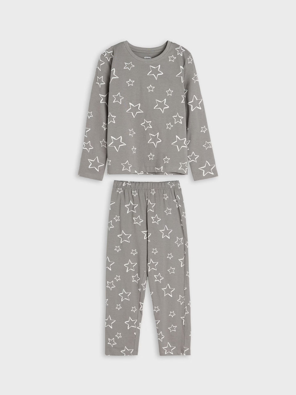 A two-piece children's pajama set in a medium gray color, featuring a long-sleeve top and matching pants with an all-over white star pattern, displayed on a light gray background.