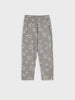 Gray pants with an all-over white star print, featuring an elastic waistband and side pockets, shown flat on a light gray background.