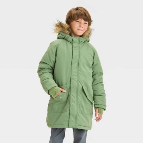 Child wearing a green winter coat with fur-lined hood on a white background