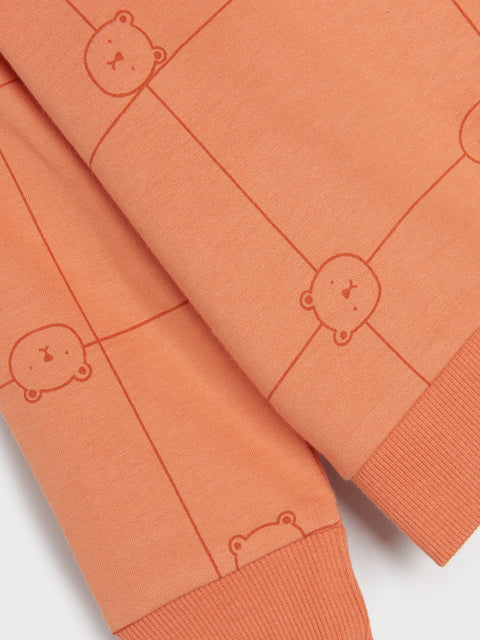Orange fabric with teddy bear patterns on a white background