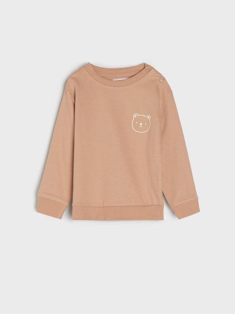 Beige sweatshirt with a bear emblem on a light gray background