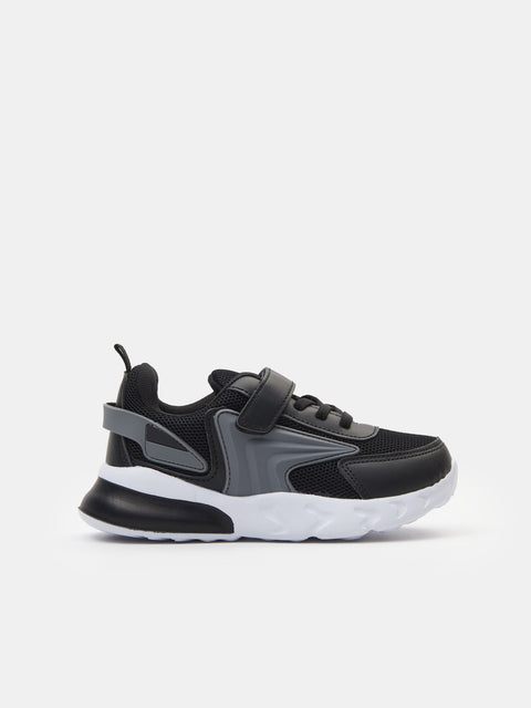 Black and gray sneaker with white sole on a light gray background