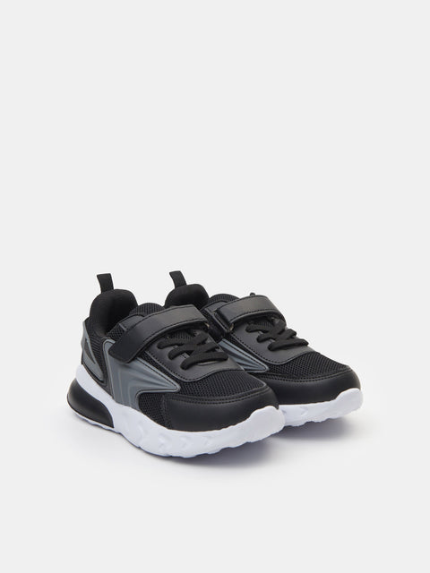 Black and gray sneakers with white soles on a light gray background