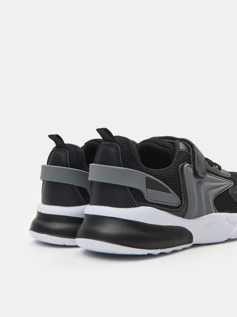Black and gray sneakers with white soles on a light gray background
