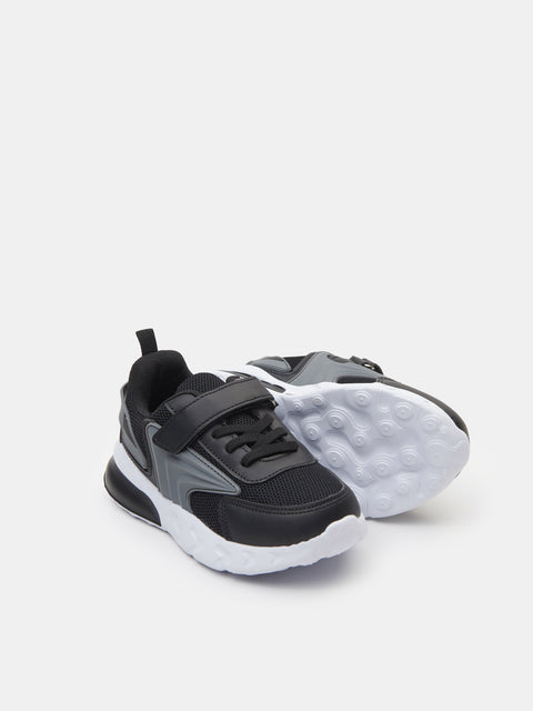 Black and gray sneakers with white sole on a light gray background
