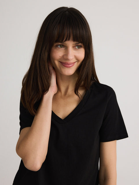 Woman wearing a black shirt against a plain background