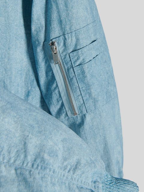 Light blue denim jacket with a zipper detail on a light gray background