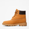 Tan boot with brown top on a white background