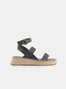 Black sandal with espadrille sole on a white background