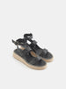 Black sandals with jute sole on a light gray background