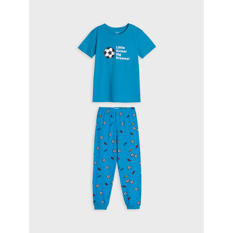 A two-piece kids' pajama set consisting of a bright blue short-sleeve t-shirt with a white soccer graphic and the text 'Little Soccer Dreamer!' on the chest, paired with matching blue jogger pants covered in a small soccer ball and soccer player print.