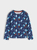 A long-sleeve crewneck shirt for kids, featuring an all-over space-themed print of astronauts and rockets on a navy blue background, shown against a light gray studio backdrop.