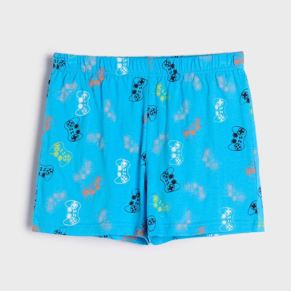 Bright blue shorts with an all-over pattern of cartoon game controllers in black, white, yellow, and orange, displayed flat against a light gray background.