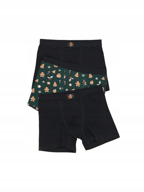 Two pairs of black boxer briefs with festive patterns on a white background