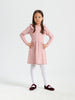 Young girl wearing a pink dress with ruffled sleeves on a white background