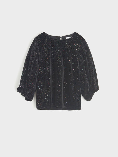 Black glittery blouse on a light gray background