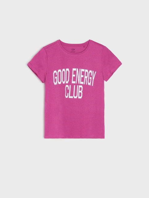 Pink t-shirt with 'Good Energy Club' text on a light gray background