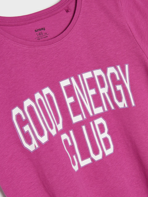 Pink t-shirt with 'GOOD ENERGY CLUB' text on a white background