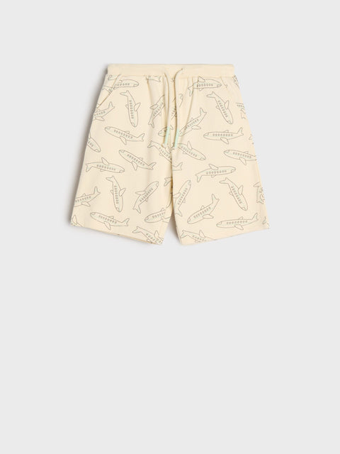 Beige shorts with shark pattern on a white background
