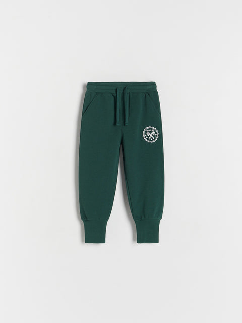 Green sweatpants with a logo on a white background