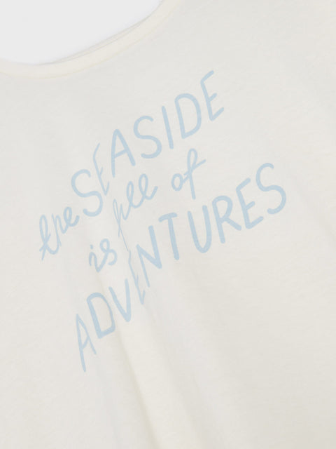 Text 'The Seaside is Full of Adventures' on a light background