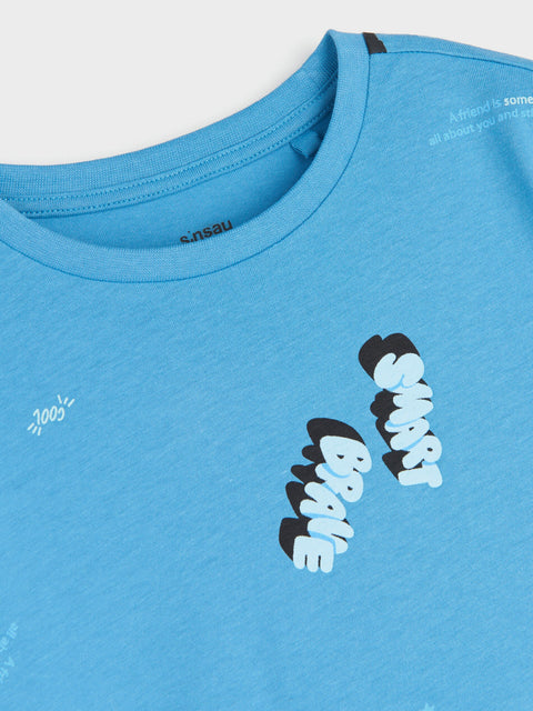 Blue t-shirt with text and branding on a light gray background