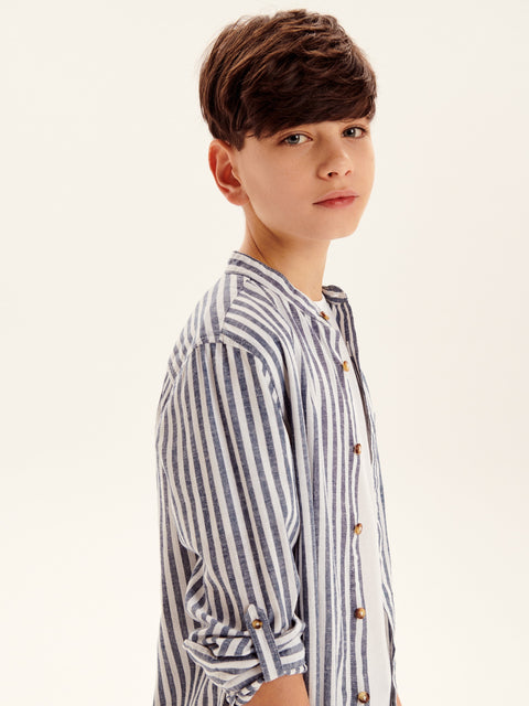 Young boy wearing a striped shirt against a plain background