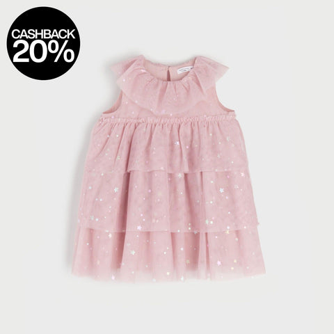 Pink dress with white polka dots on a light gray background