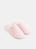 Pair of pink slippers on a white background