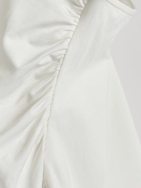 Close-up of a white fabric with ruched detail