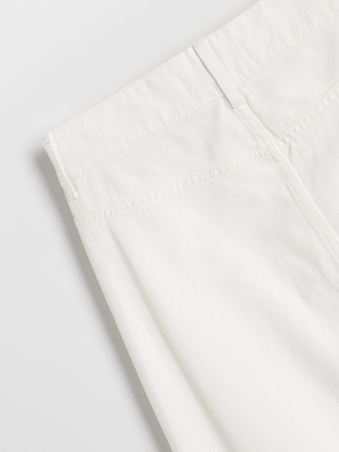 White fabric with a subtle pattern on a light gray background