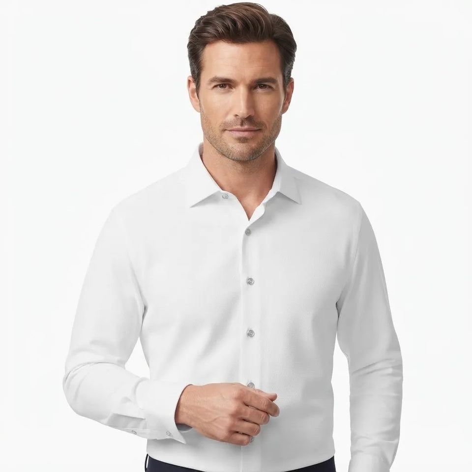 A man wearing a crisp white long-sleeve button-down dress shirt, shown from the chest up against a clean white studio background.