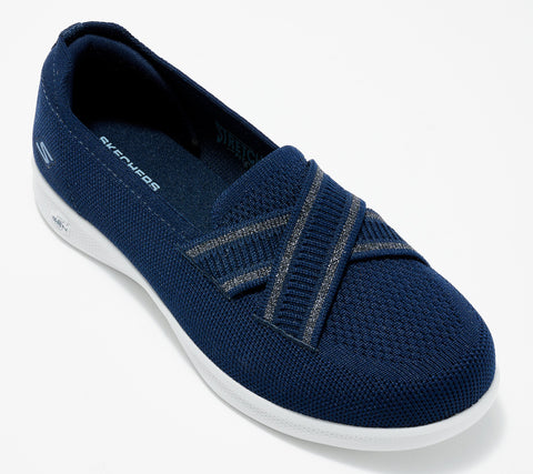 Navy slip-on shoe with white sole on a light gray background
