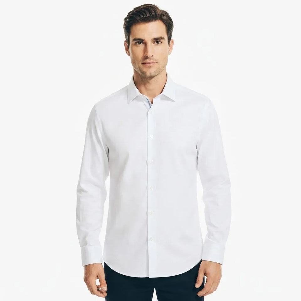 A man wearing a white long-sleeve button-down dress shirt with dark trousers, standing against a plain white studio background.