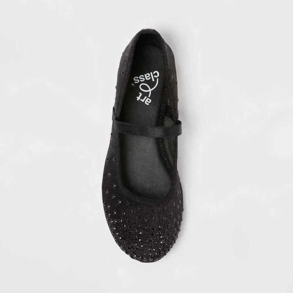 Black ballet flat shoe with rhinestone embellishments on a light gray background